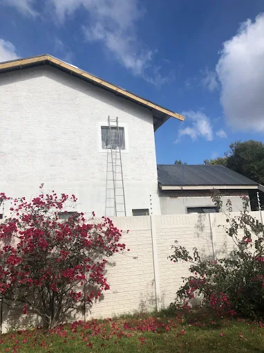 The new storey plastered and painted, with the roof covering installed