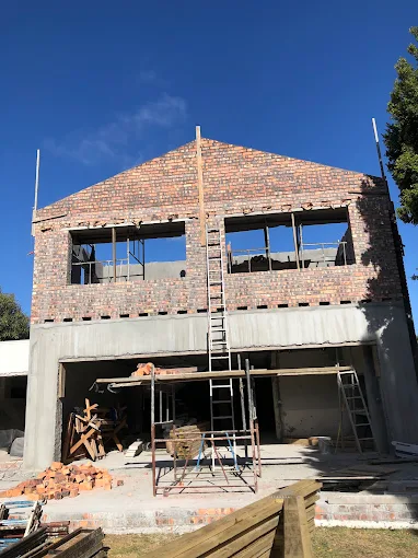 Home extension under construction, with the upper storey walls and gable built