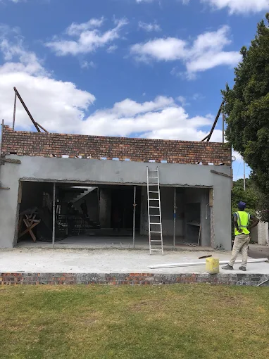 Ground floor walls and the double garage opening built, before the upper storey