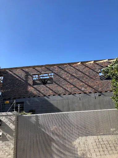 Brickwork and roof timbers viewed from the street