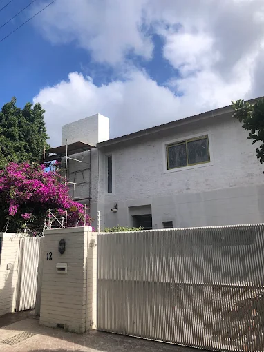 The finished double-storey cottage and garage seen from the street