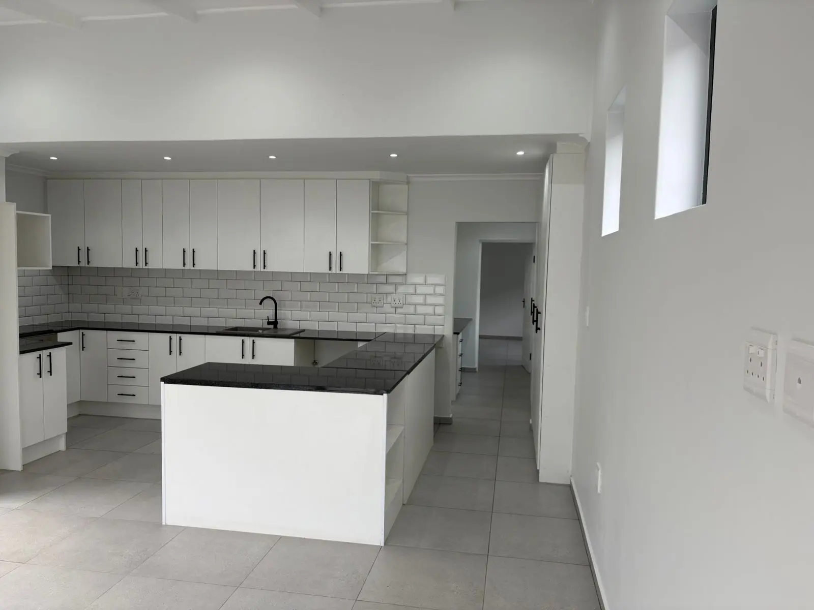 White kitchen cabinetry and central island