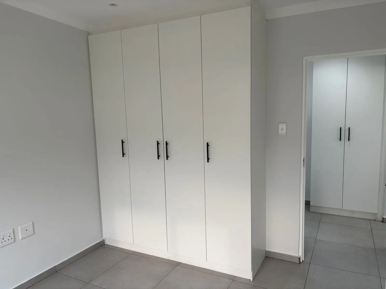 White built-in wardrobe and bedroom finishes